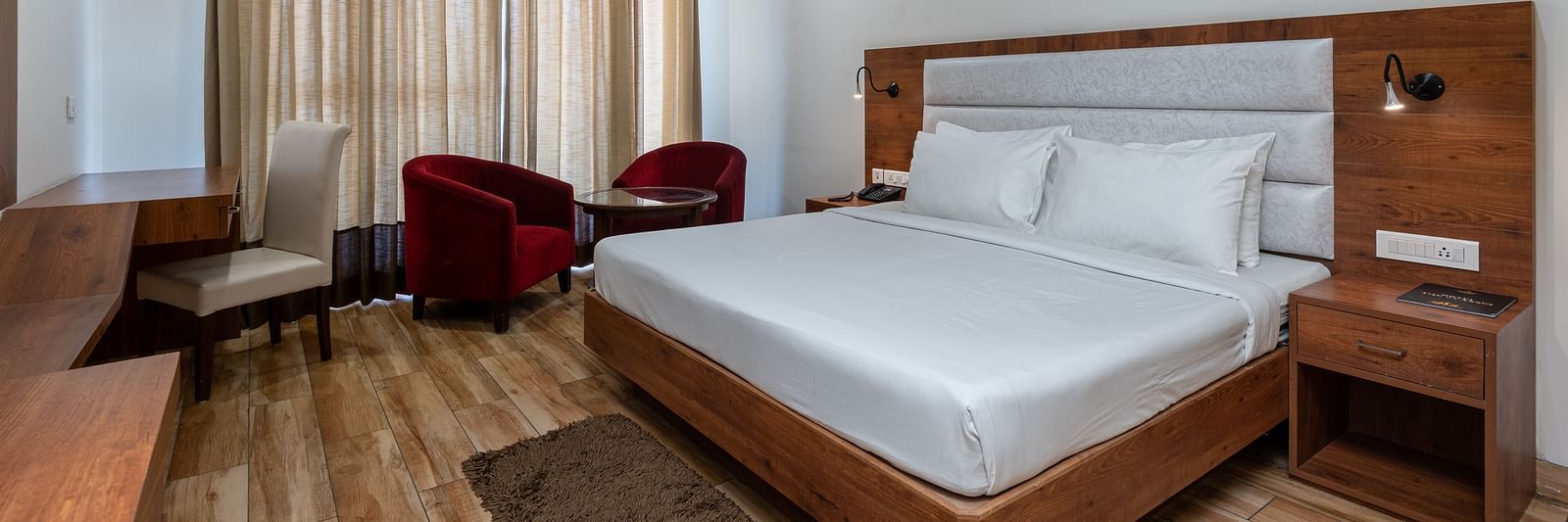 A Club Balcony Room featuring a bed, a teapoy and chairs at DLS The Classio